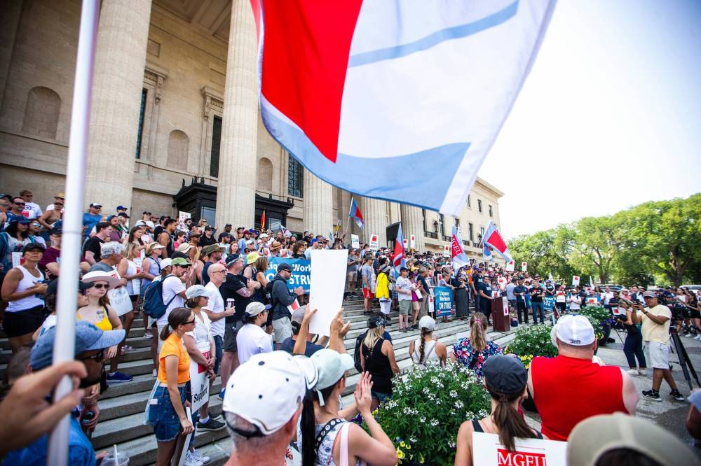 MIKAELA MACKENZIE / WINNIPEG FREE PRESS
As Manitoba Government and General Employees’ Union president Kyle Ross called on Manitobans to “fight for fairness,” supporters waved flags representing unions from across Manitoba.
