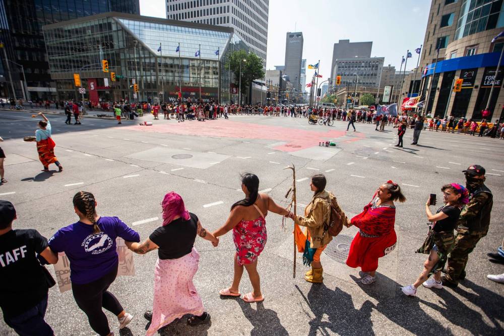 MIKAELA MACKENZIE / WINNIPEG FREE PRESS
A round dance calling for the landfills to be searched took place at Portage and Main on Thursday.