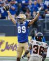 JOHN WOODS / THE CANADIAN PRESS
                                Kenny Lawler celebrates his touchdown in front of B.C. Lions’ Quincy Mauger during the first half Thursday night at IG Field.