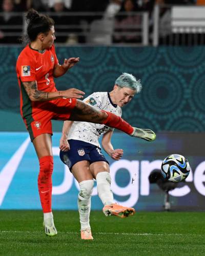 Megan Rapinoe (right) kicks the ball past Portugal’s Joana Marchao during the Women’s World Cup Group E soccer match between Portugal and the United States. (Andrew Cornaga / The Associated Press)