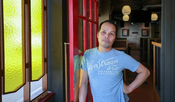 Yen Nguyen in his foyer that leads into Yen’s Kitchen + Bar on Sherbrook Street. (Ruth Bonneville / Winnipeg Free Press)