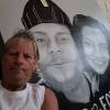 SUPPLIED
                                Kerry Tilbury poses with a large, monochrome painting of his son Carter Tilbury and his girlfriend Shayna Barnesky.