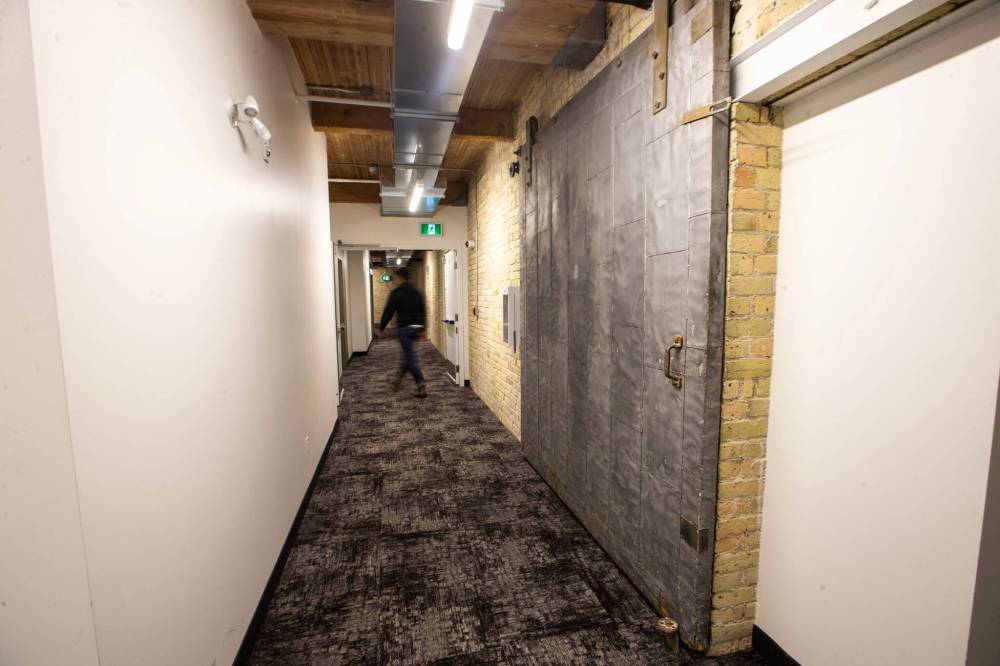 MIKAELA MACKENZIE / WINNIPEG FREE PRESS
                                The hallway at the Paulin Street Lofts. The property — which officially stands at 311 Ross Ave. — went through a few iterations, its original three-storey frame being demolished in 1910 and replaced with a new five-storey warehouse.