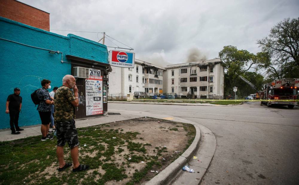 JOHN WOODS / WINNIPEG FREE PRESS
                                Crews battle a blaze in a three-storey apartment building on Mountain Avenue at Aikins Street, Sunday.