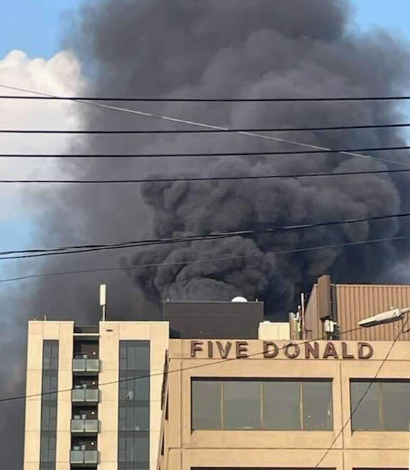 SUPPLIED PHOTO
Black smoke rises from the fire at the 18-storey building at 221 Stradbrook Ave., known as The Spot at East Village.