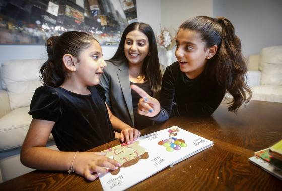 Jaspal Toor with her daughters Sureen, 8, and Sara, 4, read a Punjabi language book together in their home in Winnipeg. (John Woods / Winnipeg Free Press)