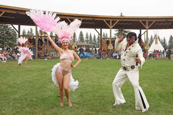 Ojibway Elvis performs for the crowd with dancer Meagan Funk beside him at the Sioux Valley Dakota Nation powwow arbour. (Tim Smith / The Brandon Sun)