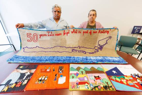 Artist and community activist Beatriz Barahona (right), with Winnipeg Chilean Association Committee chair Bernardo Jorquera, display a commemorative arpillera. (Mike Deal / Winnipeg Free Press)
