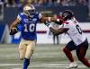 JOHN WOODS / THE CANADIAN PRESS
                                Nic Demski (left) runs for a first down Thursday night against Montreal Alouettes at IG Field.
