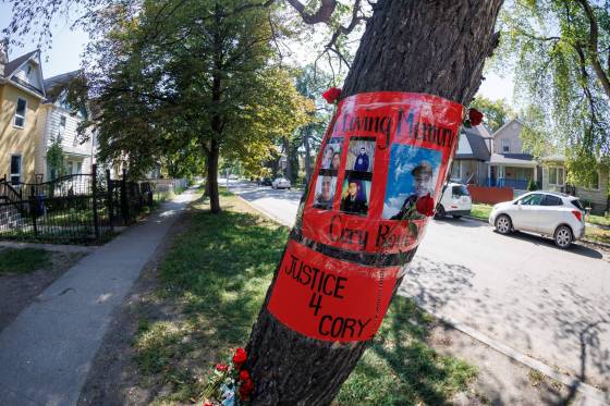 A memorial for Cory Roger Roullete is taped to the tree outside the building where he was killed on Furby Street. (Mike Deal / Winnipeg Free Press)