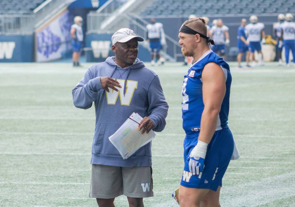 Mike Thiessen / Winnipeg Free Press
Winnipeg Blue Bombers defensive co-ordinator Richie Hall speaks with linebacker Adam Bighill at practice Thursday. Hall, who has a long history with this weekend’s opponent, loves the atmosphere surrounding the Labour Day Classic.