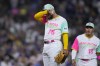 San Diego Padres relief pitcher Robert Suarez (75) wipes his face during the eighth inning of a baseball game against the Los Angeles Dodgers, Friday, Aug. 4, 2023, in San Diego. (AP Photo/Gregory Bull)
