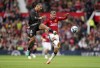 RC Lens' Facundo Medina, left, and Manchester United's Mason Mount battle for the ball during the pre-season friendly soccer match at Old Trafford, Manchester, England, Saturday August 5, 2023. (Nick Potts/PA via AP)