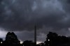 Storm clouds darken the sky over the Washington Monument, Monday, Aug. 7, 2023, in Washington. Thousands of federal employees were sent home early Monday as the Washington area faced a looming forecast for destructively strong storms, including tornadoes, hail and lightning. (AP Photo/Jacquelyn Martin)