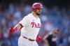 Philadelphia Phillies' Kyle Schwarber reacts after hitting a two-run home run against Washington Nationals pitcher Trevor Williams during the third inning of the first baseball game in a doubleheader, Tuesday, Aug. 8, 2023, in Philadelphia. (AP Photo/Matt Slocum)