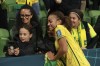 Jamaica's Solai Washington, centre, take selfie with fans after the Women's World Cup Group F soccer match between Jamaica and Brazil in Melbourne, Australia, Wednesday, Aug. 2, 2023. (AP Photo/Hamish Blair)