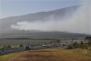 Smoke blows across the slope of Haleakala volcano on Maui, Hawaii, as a fire burns in Maui's upcountry region on Tuesday, Aug. 8. 2023. Several Hawaii communities were forced to evacuate from wildfires that destroyed at least two homes as of Tuesday as a dry season mixed with strong wind gusts made for dangerous fire conditions. (Matthew Thayer/The Maui News via AP)