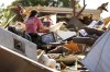 File - Mariana Valenzuela sifts through the tornado damaged home of her aunt and cousins in Perryton, Texas, on June, 16, 2023. A series of severe thunderstorms in the U.S. resulted in $34 billion in insured losses during the first half of the year, the highest amount ever for insured losses in the period, according to Swiss Re Group. (AP Photo/David Erickson, File)