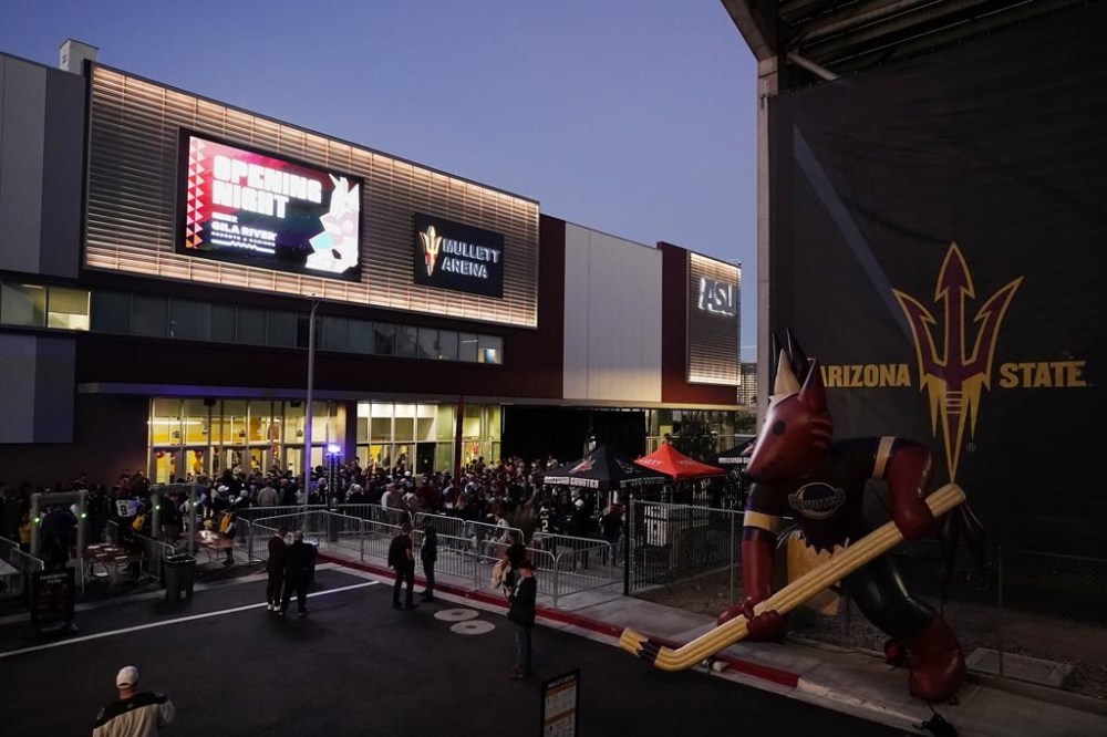 FILE - Arizona Coyotes fans wait for the doors to open prior to the Coyotes' home-opening NHL hockey game against the Winnipeg Jets at Mullett Arena in Tempe, Ariz., Oct. 28, 2022. The Coyotes say owner Alex Meruelo has executed a letter of intent to buy a piece of land for a potential arena in Mesa, Arizona. The move comes months after voters in Tempe rejected a referendum to construct an arena there for the NHL club. (AP Photo/Ross D. Franklin, File)