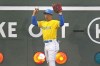 Boston Red Sox left fielder Masataka Yoshida holds up the ball after missing the catch on ball hit by Kansas City Royals' Kyle Isbel during the second inning of a baseball game at Fenway Park, Wednesday, Aug. 9, 2023, in Boston. The ball broke the lens of the out indicator light, resting inside the scoreboard for a ground-rule double. (AP Photo/Charles Krupa)