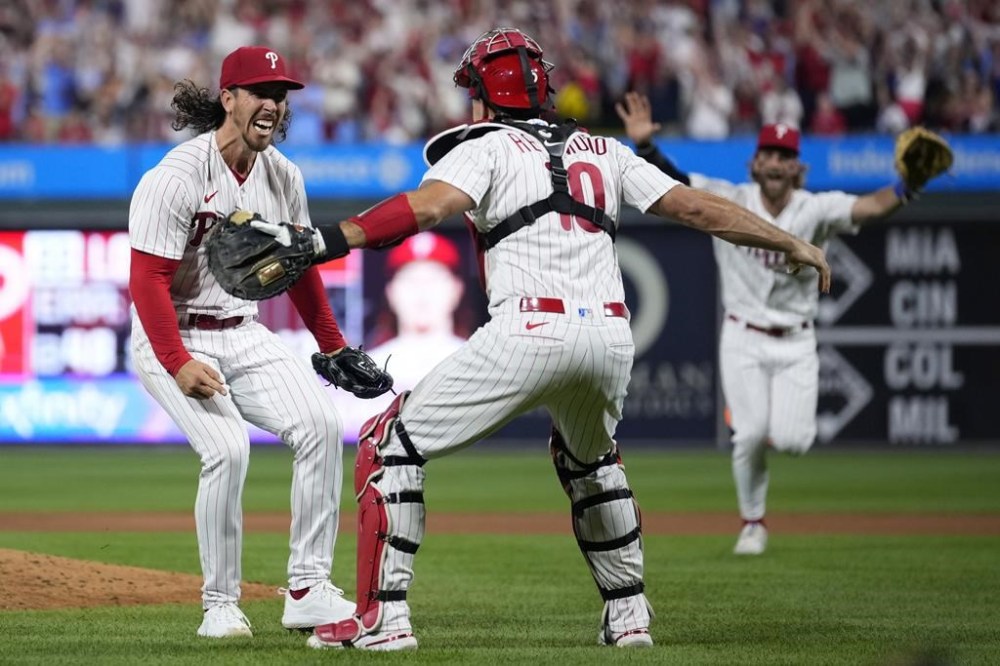 Philadelphia Phillies pitcher Michael Lorenzen, left, and J.T. Realmuto celebrate after Lorenzen's no-hitter during a baseball game against the Washington Nationals, Wednesday, Aug. 9, 2023, in Philadelphia. (AP Photo/Matt Slocum)
