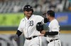 Detroit Tigers designated hitter Miguel Cabrera pats first base coach Alfredo Amezaga on the head after a single during the seventh inning of a baseball game against the Minnesota Twins, Wednesday, Aug. 9, 2023, in Detroit. (AP Photo/Carlos Osorio)