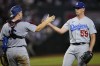 Los Angeles Dodgers' relief pitcher Evan Phillips, right, greets catcher Will Smith after a baseball game against the Arizona Diamondbacks, Wednesday, Aug. 9, 2023, in Phoenix. The Dodgers defeated the Diamondbacks 2-0. (AP Photo/Matt York)