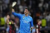 FILE - Real Madrid's goalkeeper Thibaut Courtois waves to fans at the end of the Champions League semifinal first leg soccer match between Real Madrid and Manchester City at the Santiago Bernabeu stadium in Madrid, Spain, Tuesday, May 9, 2023. Real Madrid says goalkeeper Thibaut Courtois has torn a ligament in his left knee and will require surgery. Local media reports that the injury occurred during training. (AP Photo/Manu Fernandez, File)