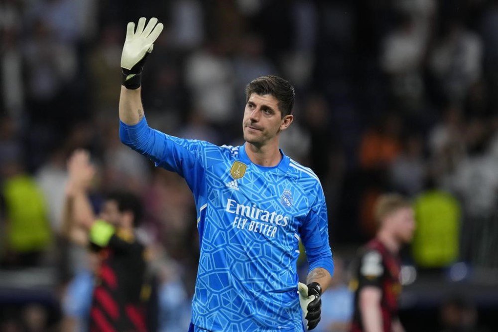 FILE - Real Madrid's goalkeeper Thibaut Courtois waves to fans at the end of the Champions League semifinal first leg soccer match between Real Madrid and Manchester City at the Santiago Bernabeu stadium in Madrid, Spain, Tuesday, May 9, 2023. Real Madrid says goalkeeper Thibaut Courtois has torn a ligament in his left knee and will require surgery. Local media reports that the injury occurred during training. (AP Photo/Manu Fernandez, File)