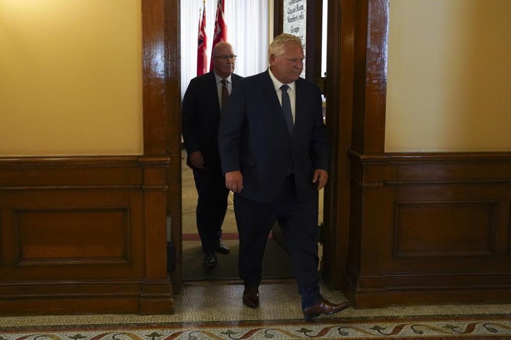 The Ontario Integrity Commissioner says it is reviewing a request from Premier Doug Ford's office to investigate a senior politician about his role in removing Greenbelt lands for housing development. Ontario Premier Doug Ford, right, followed by Minister of Municipal Affairs and Housing Steve Clark leave a press conference following the release of the Auditor General’s Special Report on Changes to the Greenbelt, at Queens Park, in Toronto, Wednesday, Aug. 9, 2023. THE CANADIAN PRESS/Arlyn McAdorey