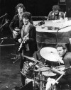 FILE - The Band, featuring Richard Manuel on piano, Levon Helm on drums, lead guitarist Robbie Robertson (smiling), bass guitarist Rick Danko, and organist Garth Hudson (not shown), take the stage for their final live performance before a crowd of 5,000 at Winterland Auditorium in San Francisco on Nov. 27, 1976. Robertson, The Band’s lead guitarist and songwriter who in such classics as “The Weight” and “Up on Cripple Creek” mined American music and folklore and helped reshape contemporary rock, died Wednesday, Aug. 9, 2023. He was 80. (AP Photo/John Storey, File)