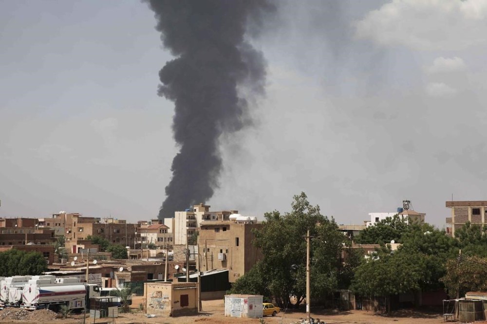 FILE - Smoke rises over Khartoum, Sudan, Thursday, June 8, 2023, as fighting between the Sudanese army and paramilitary Rapid Support Forces continues. Nearly four months of violent street battles between the Sudanese Army and the paramilitary known as the Rapid Support Forces have made funerals a near impossibility in Khartoum. Amid the chaos, residents and local medical groups say corpses lie rotting in the capital’s streets. (AP Photo, File)