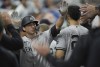 New York Yankees' Kyle Higashioka is congratulated after scoring against the Miami Marlins during the fourth inning of a baseball game, Friday, Aug. 11, 2023, in Miami. (AP Photo/Jim Rassol)