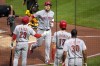 Cincinnati Reds' Luke Maile, second from left, returns to the dugout after hitting a three-run home run off Pittsburgh Pirates starting pitcher Johan Oviedo during the fourth inning of a baseball game in Pittsburgh, Friday, Aug. 11, 2023. (AP Photo/Gene J. Puskar)