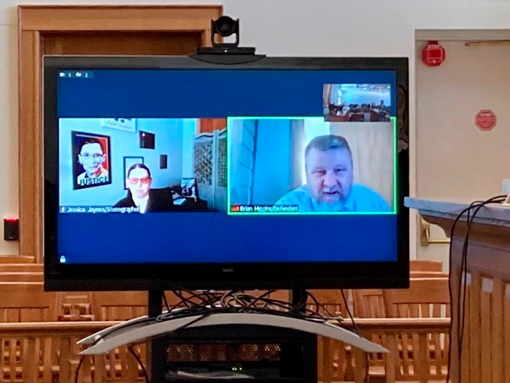 FILE - Brian Higgins of Wisconsin Dells, Wis., testifies by video linkup in Michigan's Antrim County Circuit Court in Bellaire, Mich., March 15, 2023, as he pleads guilty to attempting to provide material support for terrorism in the plot to kidnap Michigan Gov. Gretchen Whitmer. Fourteen people accused of involvement with the scheme have been charged in three different courts. This week's confrontation that ended with FBI agents fatally shooting a 74-year-old Utah man who threatened to assassinate President Joe Biden was just the latest example of how violent rhetoric has created a more perilous political environment across the U.S.(AP Photo/John Flesher)