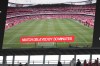 The stadium screen announces a 30 minutes delay of the English Premier League soccer match between Arsenal and Nottingham Forest at Emirates stadium in London, Saturday, Aug. 12, 2023. (AP Photo/Kirsty Wigglesworth)