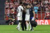 Real Madrid's Jude Bellingham, left, cheers up Eder Militao as he leaves the pitch after an injury during the Spanish La Liga soccer match between Athletic Club and Real Madrid at the San Mames stadium in Bilbao, Spain, Saturday, Aug. 12, 2023. (AP Photo/Alvaro Barrientos)