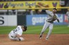 Milwaukee Brewers second baseman Brice Turang, right, throws to first base after forcing out Chicago White Sox's Gavin Sheets (32) at second base during the fourth inning of a baseball game Saturday, Aug. 12, 2023, in Chicago. (AP Photo/Paul Beaty)