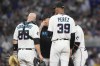 Miami Marlins pitching coach Mel Stottlemyre talks to catcher Jacob Stallings (58) and starting pitcher Eury Perez (39) on the pitching mound during the fourth inning of a baseball game against the New York Yankees, Sunday, Aug. 13, 2023, in Miami. (AP Photo/Marta Lavandier)