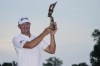 Lucas Glover holds the winner's trophy after winning the St. Jude Championship golf tournament Sunday, Aug. 13, 2023, in Memphis, Tenn. (AP Photo/George Walker IV)