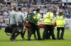 Aston Villa's Tyrone Mings is taken off the pitch on a stretcher during the English Premier League soccer match between Newcastle and Aston Villa at St. James' Park in Newcastle, England, Saturday, Aug. 12, 2023. (AP Photo/Steve Luciano)