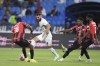 Al Ittihad's Karim Benzema, center, fights for the ball during his team match against Al Raed in Saudi Professional League, in Buraidah, Saudi Arabia, Monday, Aug. 14, 2023. (AP Photo)