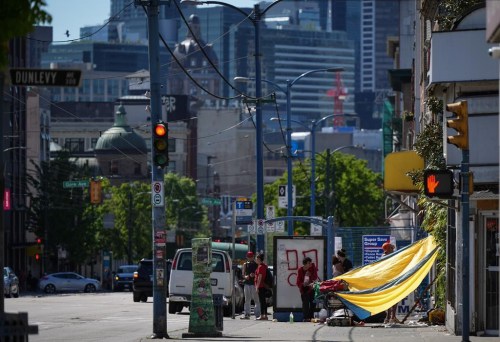 An outreach team for the Union Gospel Mission in Vancouver has been working in the city's Downtown Eastside to ensure people are aware and are prepared to cope with the latest heat spike across parts of B.C. A tarp is seen draped between a building and a shopping cart to provide shade from the sun in the Downtown Eastside of Vancouver, on Saturday, May 13, 2023. THE CANADIAN PRESS/Darryl Dyck