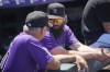Colorado Rockies manager Bud Black, left, confers with injured outfielder Charlie Blackmon, right, in the first inning of a baseball game against the Oakland Athletics, Sunday, July 30, 2023, in Denver. (AP Photo/David Zalubowski)