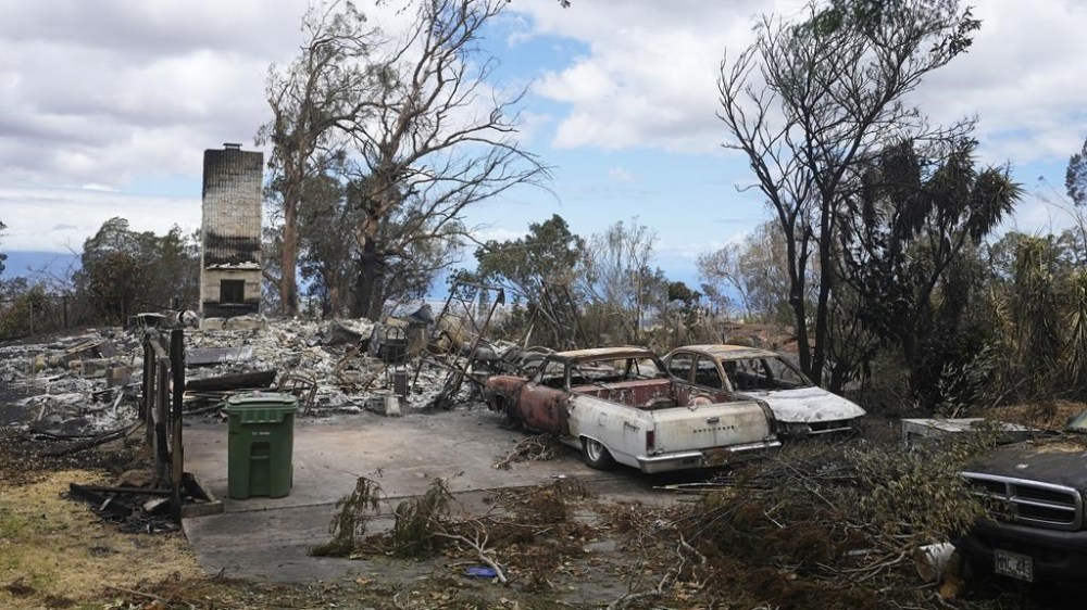 Charred vehicles sit near a wildfire-destroyed home Monday, Aug. 14, 2023, in Kula, Hawaii. The same day a wildfire ripped through Lahaina, one tore through Kula, as well. (AP Photo/Rick Bowmer)