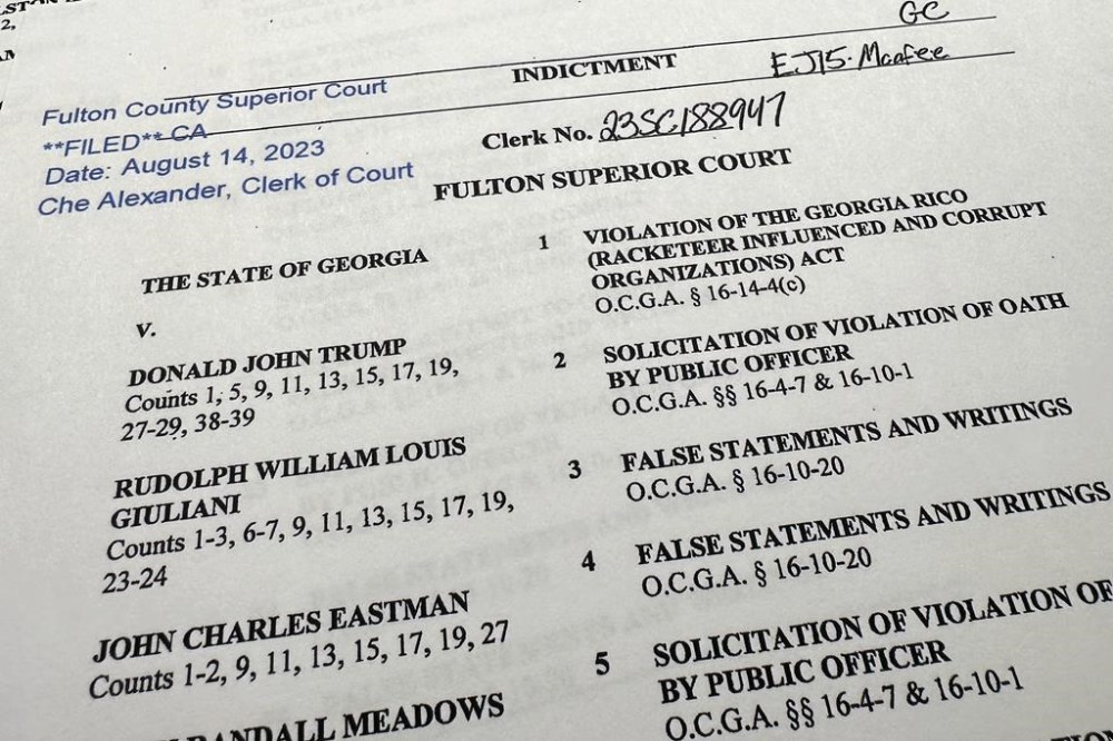 The indictment in Georgia against former President Donald Trump is photographed Monday, Aug. 14, 2023. (AP Photo/Jon Elswick)