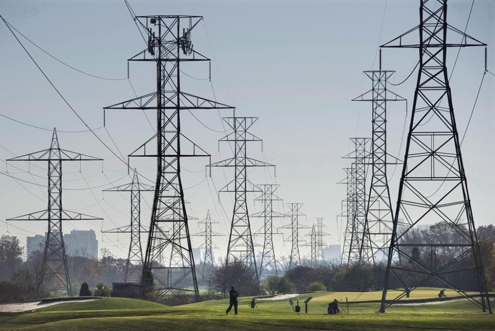 Statistics Canada says volatility in the amount Albertans paid for electricity last month helped slow the decline of Canadian energy prices for July -- one of the key reasons cited by the agency as the national inflation rate ticked up.Hydro towers are seen over a golf course in Toronto on Wednesday, Nov. 4, 2015. THE CANADIAN PRESS/Darren Calabrese