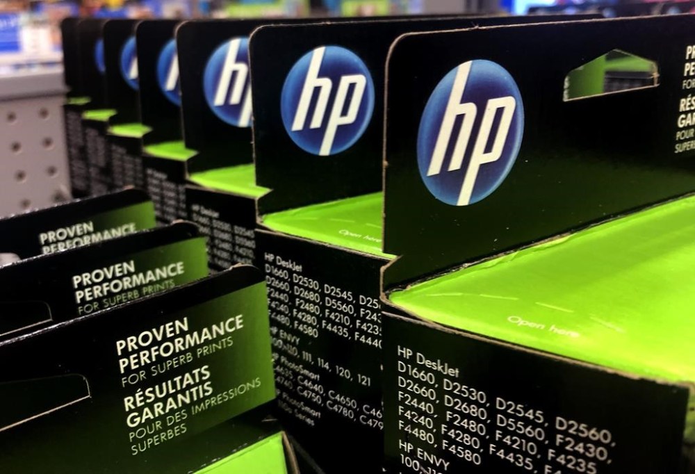 FILE - This Aug. 15, 2019, photo shows the HP logo on Hewlett-Packard printer ink cartridges at a store in Manchester, N.H. HP Inc. has failed to shunt aside claims in a lawsuit that it disables scanners and other functions on its multifunction printers whenever the ink runs low. The suit claims that HP's so-called “all-in-one” printers provide consumers no indication the devices require printer ink to scan documents or send faxes. (AP Photo/Charles Krupa, file)