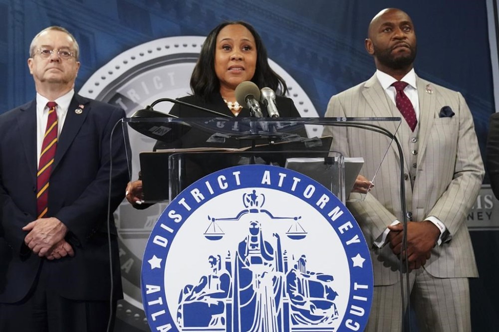 Fulton County District Attorney Fani Willis, center, speaks in the Fulton County Government Center during a news conference, Monday, Aug. 14, 2023, in Atlanta. Donald Trump’s defiant march deeper into infamy barely broke stride Tuesday after a grand jury in Georgia finally handed up another long-awaited indictment of the former president — his fourth in five months. THE CANADIAN PRESS/AP-John Bazemore