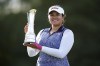 Lilia Vu of the US celebrates victory with the trophy on day four of the 2023 AIG Women's Open at Walton Heath, in Surrey, England, Sunday Aug. 13, 2023. (John Walton/PA via AP)